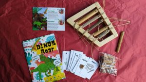 a children's activity box filled with exciting contents and learning information about dinosaurs.