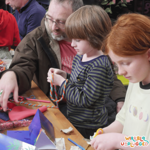 Father, son and young woman work on crafts at our shortlisted event on Environmental Chemistry