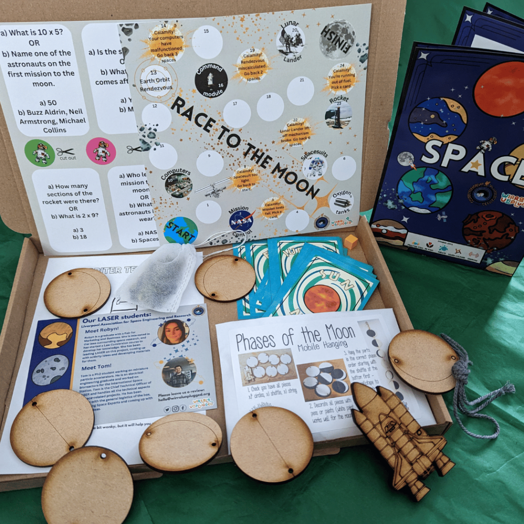Picture of our Space Box with wooden mobile, race to the moon, snap cards and board game