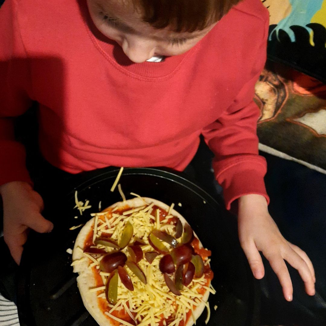 Child making a spider pizza